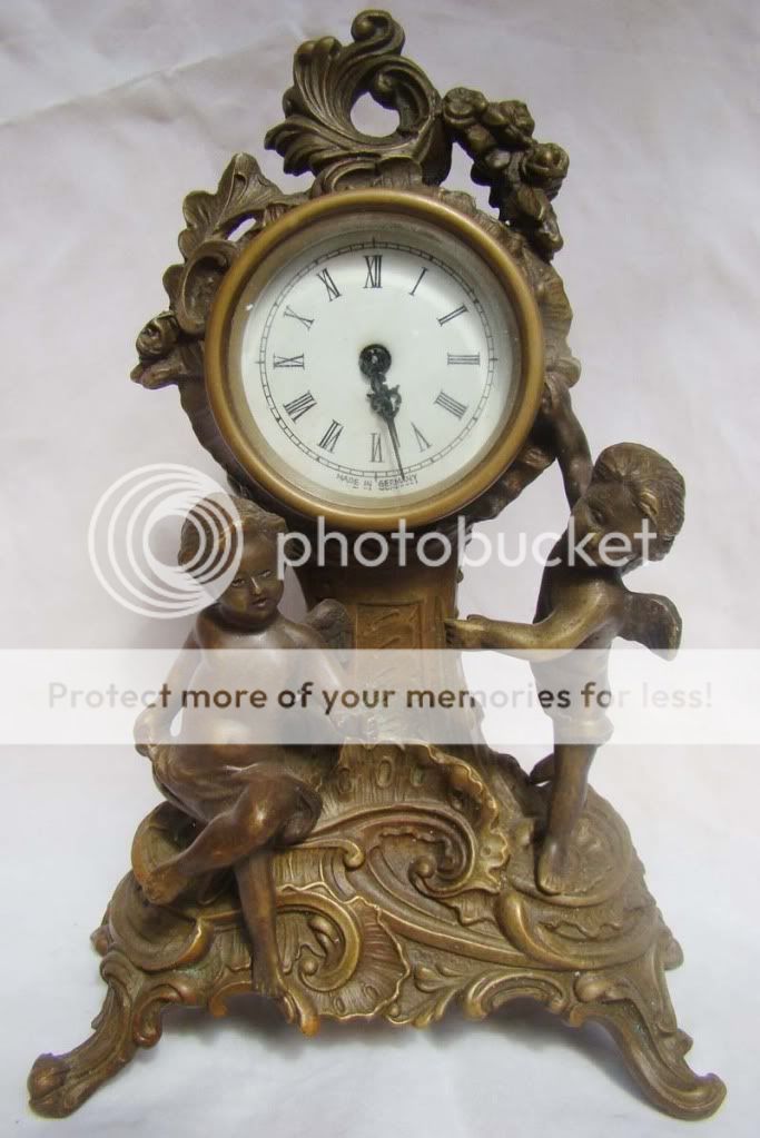   Works excellent nice Brass 2 angels with machine Clock  