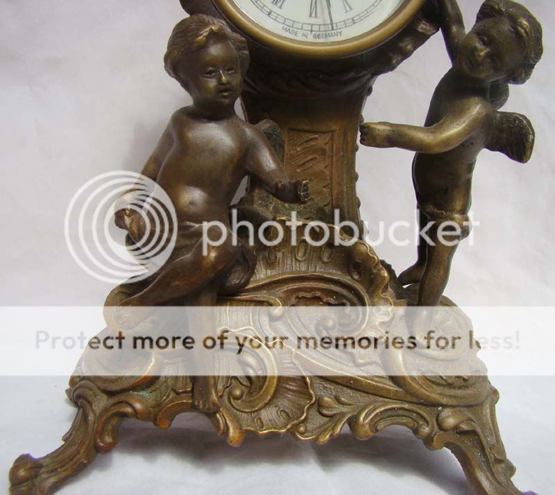   Works excellent nice Brass 2 angels with machine Clock  